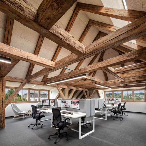 KNAUF Ceiling HERADESIGN® Fine ceiling panels in beige at office space with vaulted ceilings and wooden beams