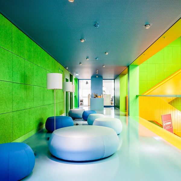 KNAUF Ceiling HERADESIGN® Superfine wood wool wall panels in green at a lounge area