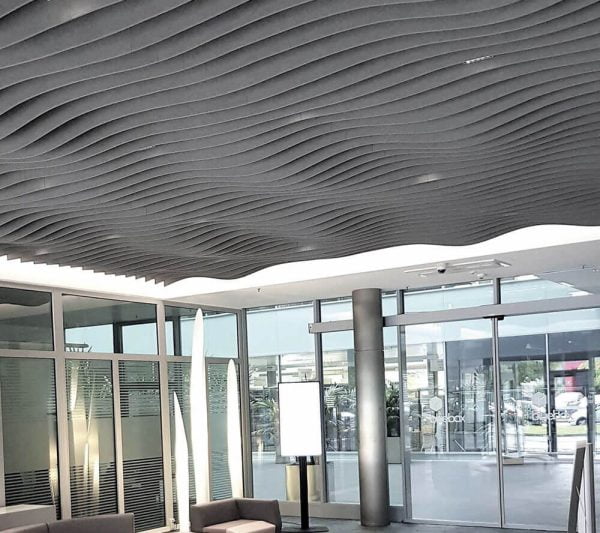 KNAUF Ceiling Armstrong Feltworks Acoustic Baffles with acoustical felt curved profile in grey at an entranceway