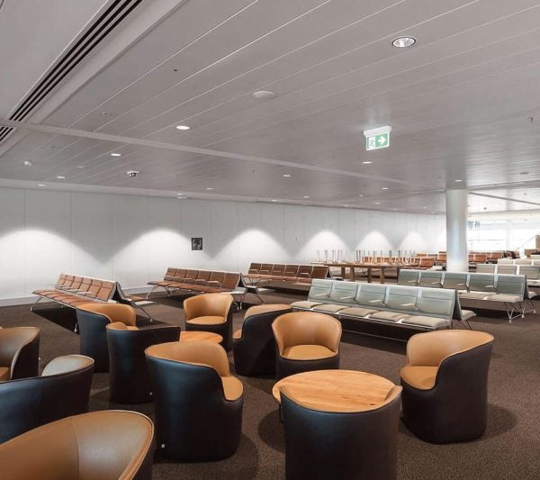 KNAUF Ceiling Armstrong C-plank & S-plank with a global white micro perforated at airport waiting area with circular chair