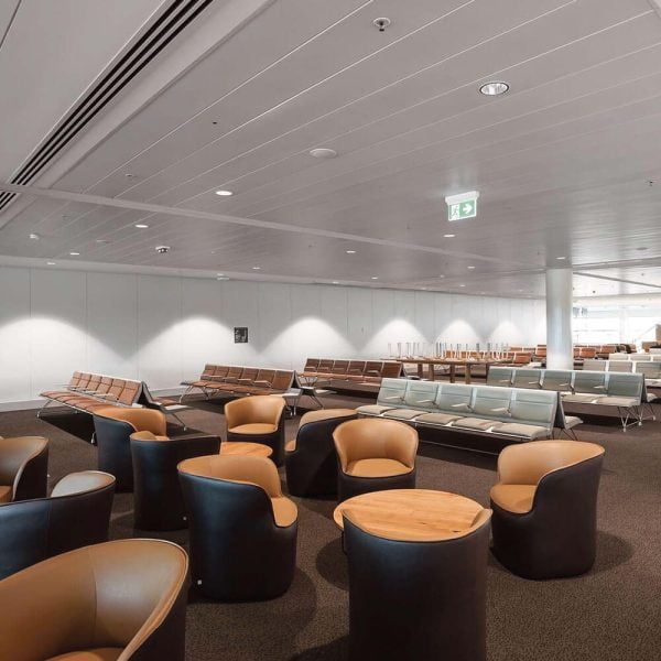 KNAUF Ceiling Armstrong C-plank & S-plank with a global white micro perforated at airport waiting area with circular chair