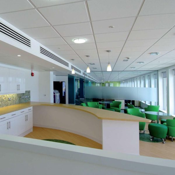 KNAUF Ceiling Armstrong Dune ceiling tiles in a room with green chairs and a white counters
