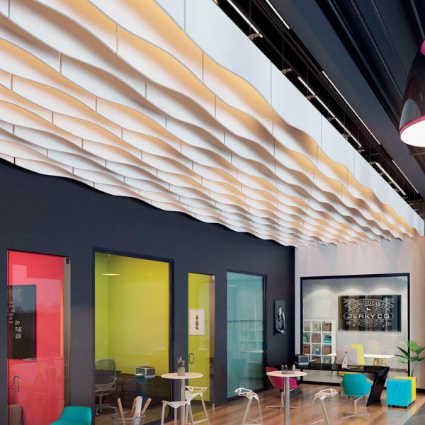 KNAUF Ceiling Armstrong Soundscapes Baffles Curve with a white 4 foot length waveform edge baffle panel and lights installed in a colourful office