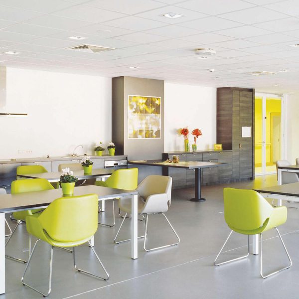 KNAUF Ceiling AMF THERMATEX Thermofon in a office pantry with a lime green and white cantilever chair with white ceiling tiles