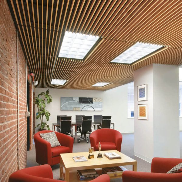 KNAUF Ceiling Armstrong Grille WoodWorks Grille ceiling tiles with vertical blades at a sitting area.