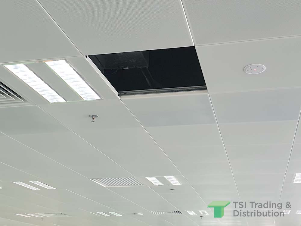 TSI Trading commercial project using KNAUF Ceiling Solutions Armstrong Metalworks Clip-in in white ceiling tiles with an empty tile and light fixtures
